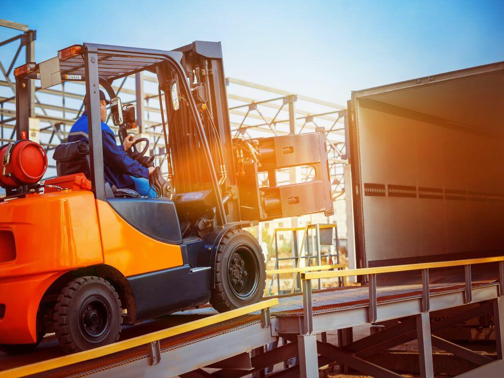 Flatbed Truck Carrying Forklift